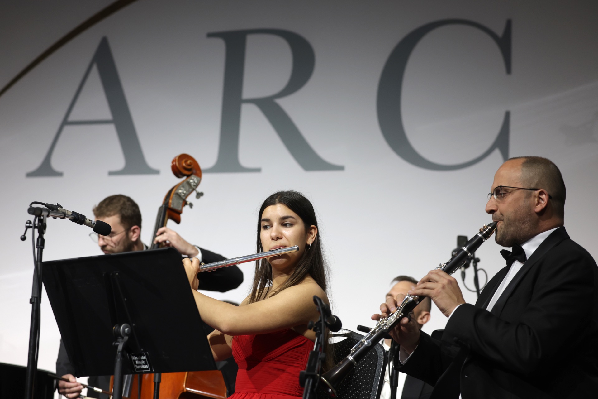 Camerata Bulgarica performing at the ARC conference, the ARC backdrop behind the ensemble
